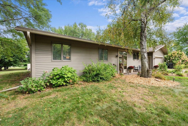 view of front of home with a garage and a front yard