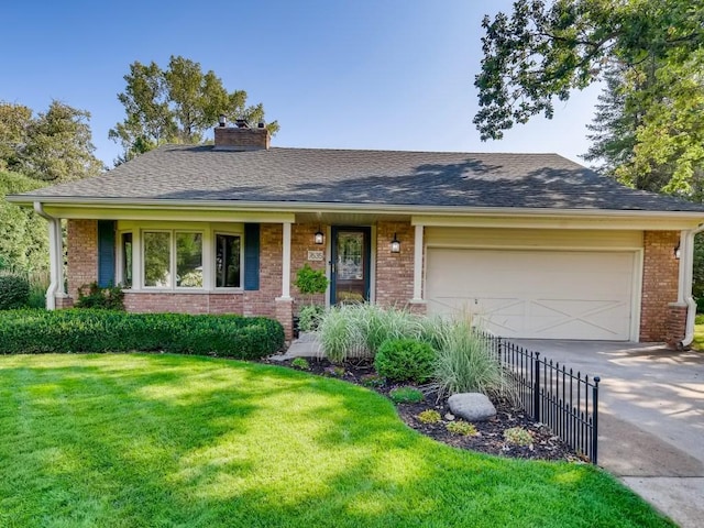 ranch-style home featuring a garage, a shingled roof, concrete driveway, a front lawn, and brick siding