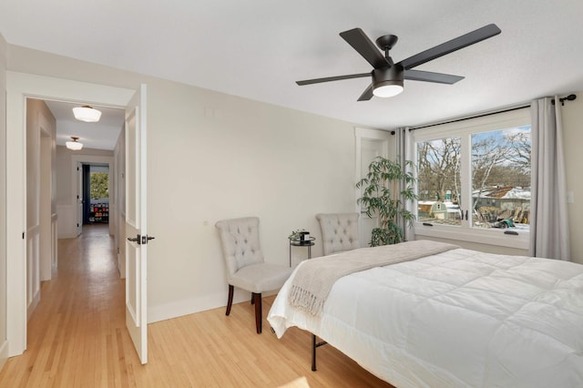 bedroom with ceiling fan and light wood-style flooring