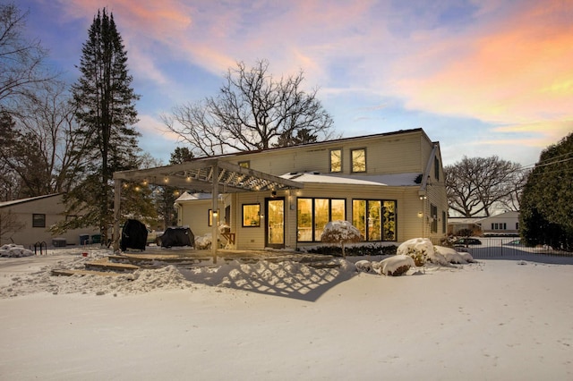 snow covered property with fence