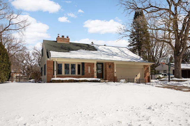 view of front of house with a garage, brick siding, and a chimney