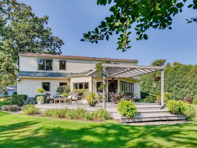 rear view of house featuring a yard, a pergola, and a wooden deck