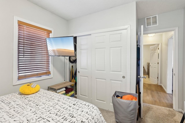 bedroom with visible vents and a closet