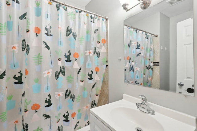 bathroom with a shower with shower curtain, visible vents, and vanity