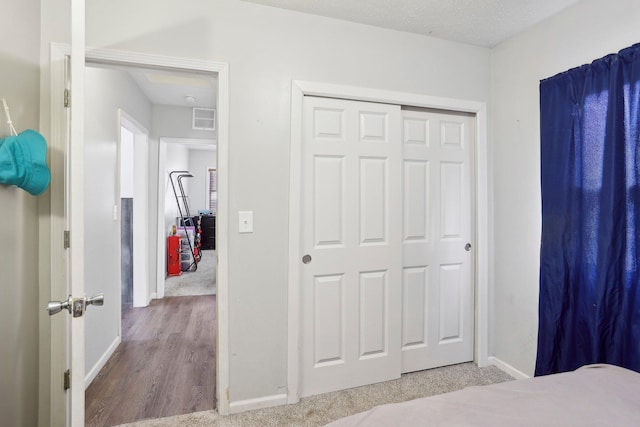 bedroom featuring a closet, baseboards, and visible vents