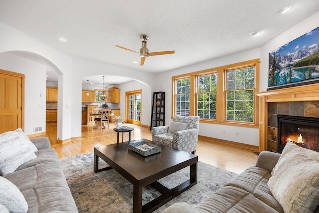 11050 Sweetwater Path, Woodbury, MN 55129 - living area featuring arched walkways, a ceiling fan, light wood-style floors, baseboards, and recessed lighting