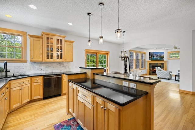 11050 Sweetwater Path, Woodbury, MN 55129 - kitchen with dishwasher, a sink, dark countertops, a fireplace, and a textured ceiling