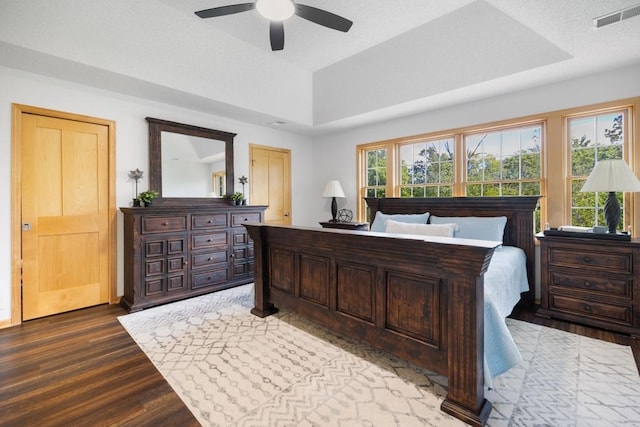 11050 Sweetwater Path, Woodbury, MN 55129 - bedroom with a tray ceiling, wood finished floors, and ceiling fan