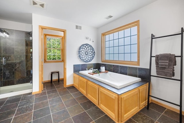 11050 Sweetwater Path, Woodbury, MN 55129 - bathroom featuring baseboards, a shower stall, and a bath
