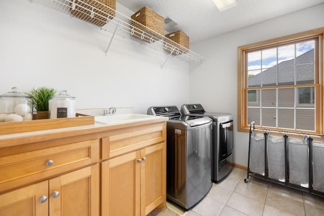 11050 Sweetwater Path, Woodbury, MN 55129 - laundry area featuring separate washer and dryer, light tile patterned flooring, and cabinet space