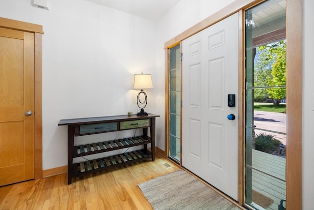 11050 Sweetwater Path, Woodbury, MN 55129 - entrance foyer with light wood finished floors and baseboards