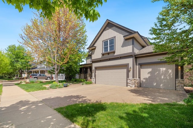 11050 Sweetwater Path, Woodbury, MN 55129 - view of front facade with stone siding, driveway, a garage, and board and batten siding