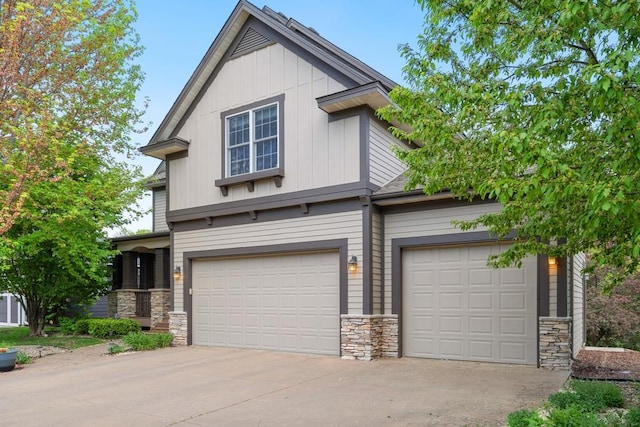 11050 Sweetwater Path, Woodbury, MN 55129 - view of front of home with stone siding, concrete driveway, board and batten siding, and an attached garage