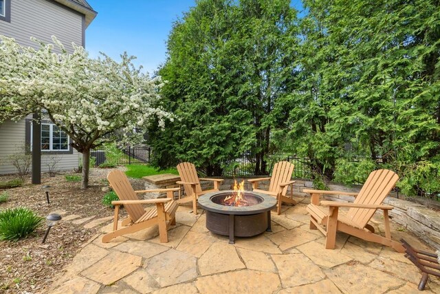 11050 Sweetwater Path, Woodbury, MN 55129 - view of patio featuring an outdoor fire pit and fence