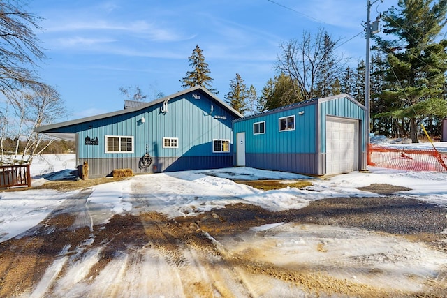 exterior space with a garage, an outdoor structure, and fence