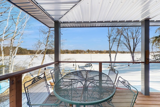 snow covered deck featuring outdoor dining space