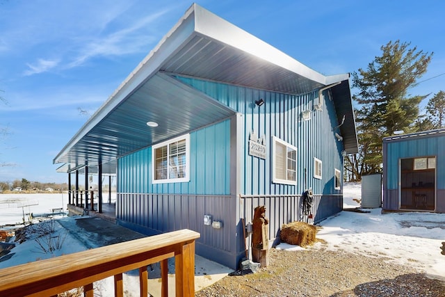 snow covered property featuring board and batten siding