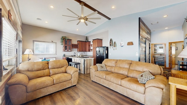 living area with recessed lighting, high vaulted ceiling, wood finished floors, and a ceiling fan