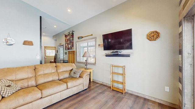 living room featuring recessed lighting, baseboards, and wood finished floors