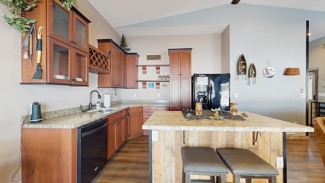 kitchen with a kitchen island, dark wood-style flooring, a sink, black appliances, and vaulted ceiling