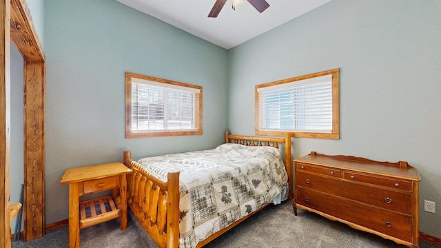 carpeted bedroom featuring multiple windows and a ceiling fan