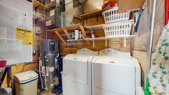 washroom with washer and clothes dryer, laundry area, and hybrid water heater