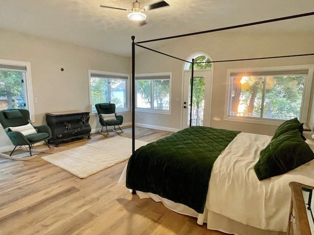 bedroom featuring light wood-type flooring, access to outside, and baseboards