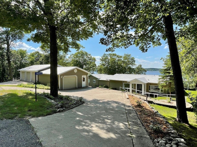 ranch-style house with a garage and concrete driveway