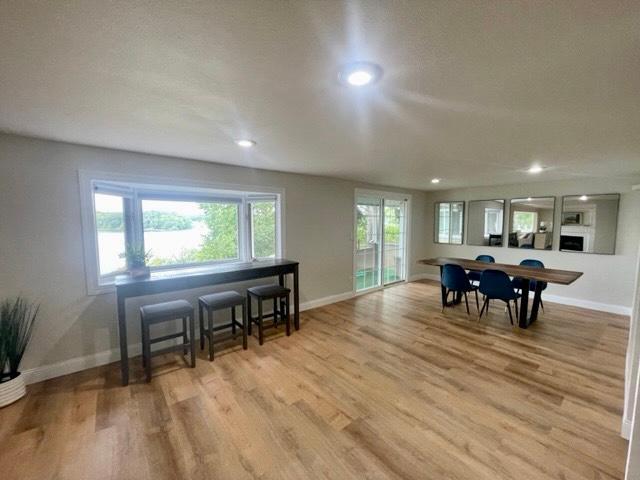 dining space with light wood-style floors, baseboards, and recessed lighting