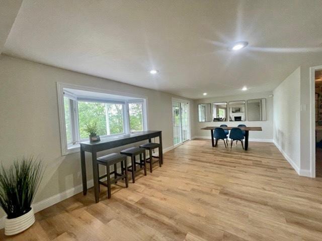 interior space featuring light wood-style floors, recessed lighting, and baseboards