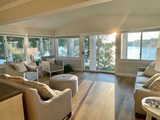 sunroom / solarium with lofted ceiling and a water view