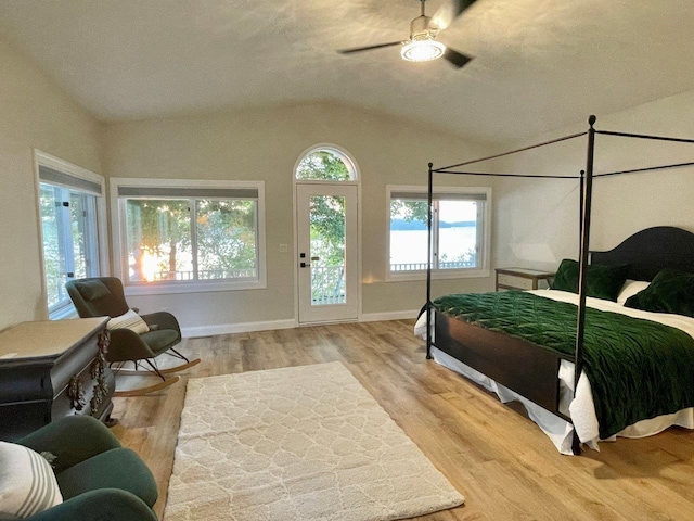 bedroom featuring a ceiling fan, vaulted ceiling, baseboards, and wood finished floors