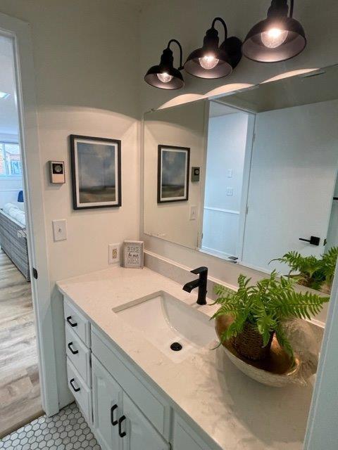 bathroom featuring ensuite bathroom and vanity