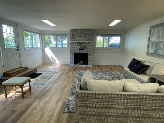 living room with a fireplace and wood finished floors