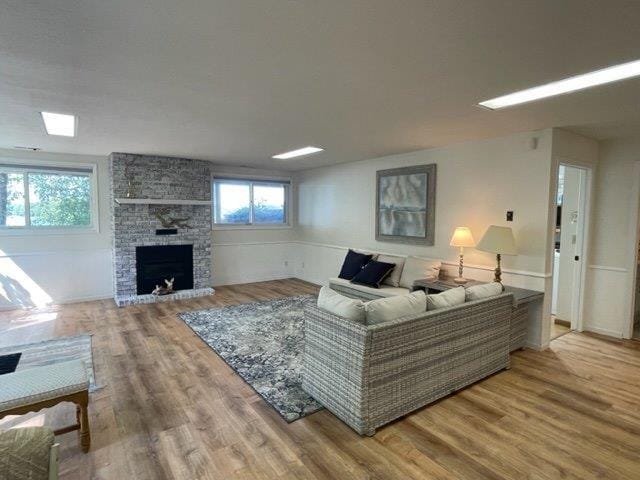 living area with a fireplace and wood finished floors