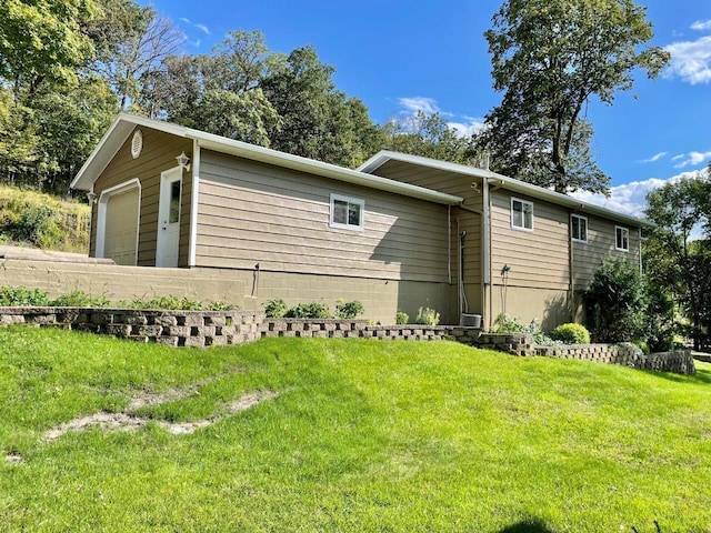 view of side of home with a lawn