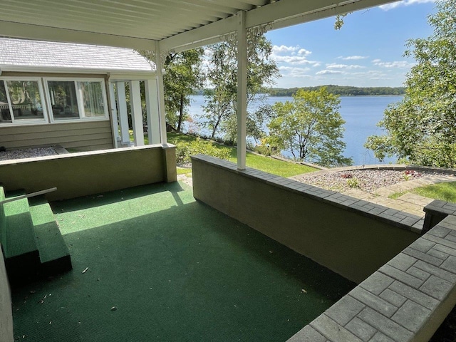 unfurnished sunroom featuring a water view