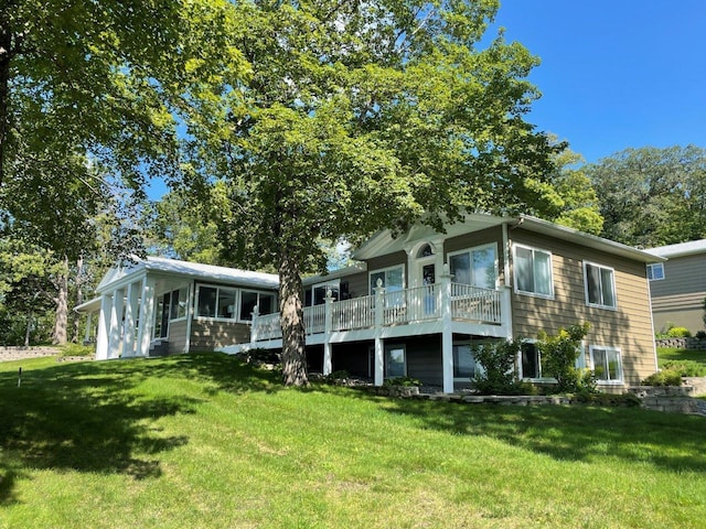 back of house featuring a yard and a sunroom