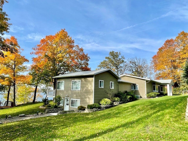 view of side of property featuring a yard