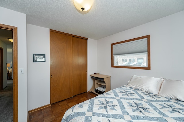 bedroom with a closet and a textured ceiling