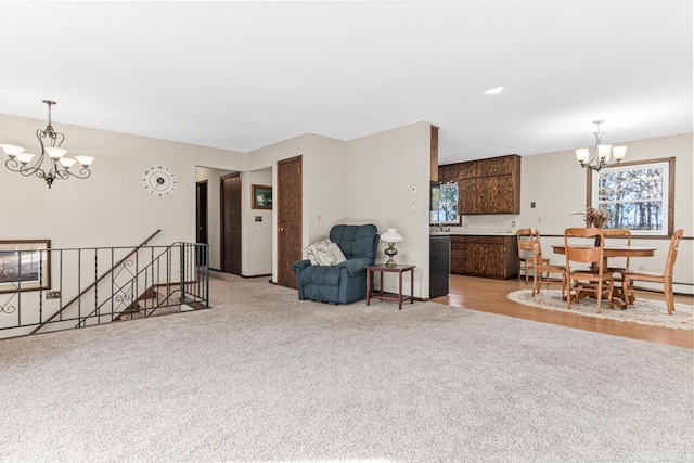 living area with light carpet and a notable chandelier