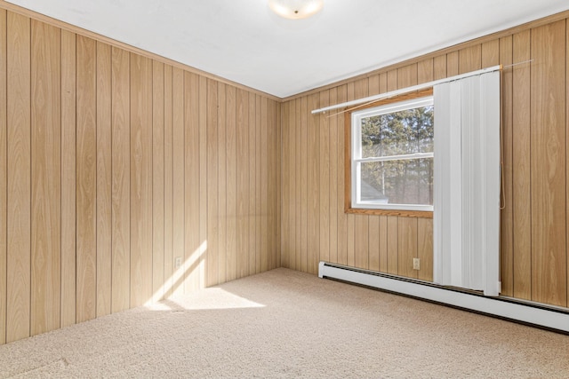 empty room with baseboard heating, wooden walls, and carpet floors