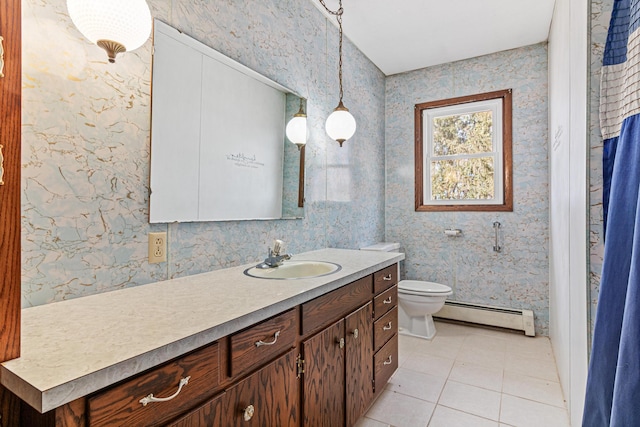 bathroom with a baseboard heating unit, vanity, and wallpapered walls