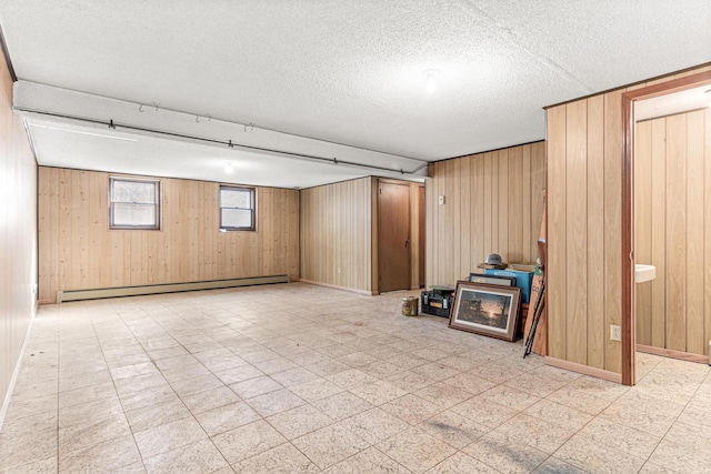 basement with tile patterned floors, a baseboard radiator, and wooden walls