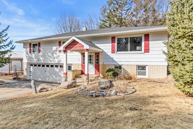 split foyer home featuring a garage, driveway, and a chimney