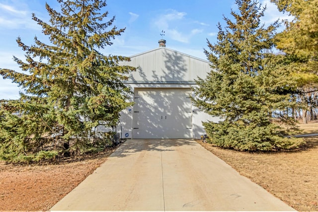 view of front of property featuring concrete driveway and a garage