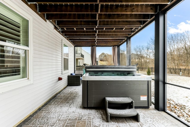 view of patio / terrace with fence and a hot tub