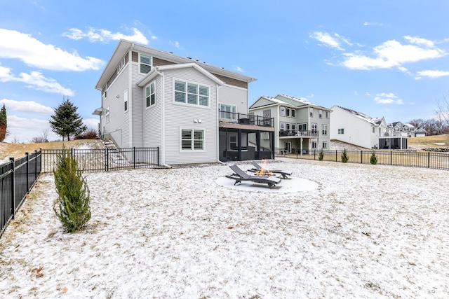 rear view of house with a fire pit, fence, and a residential view