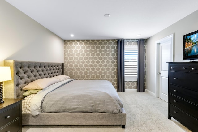 bedroom with recessed lighting, an accent wall, baseboards, carpet, and wallpapered walls