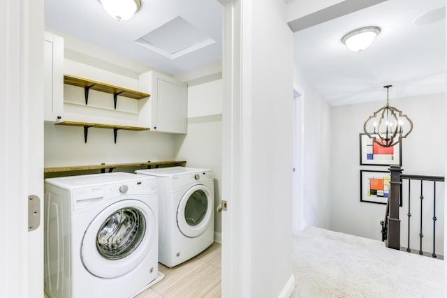 laundry area with cabinet space, attic access, and independent washer and dryer